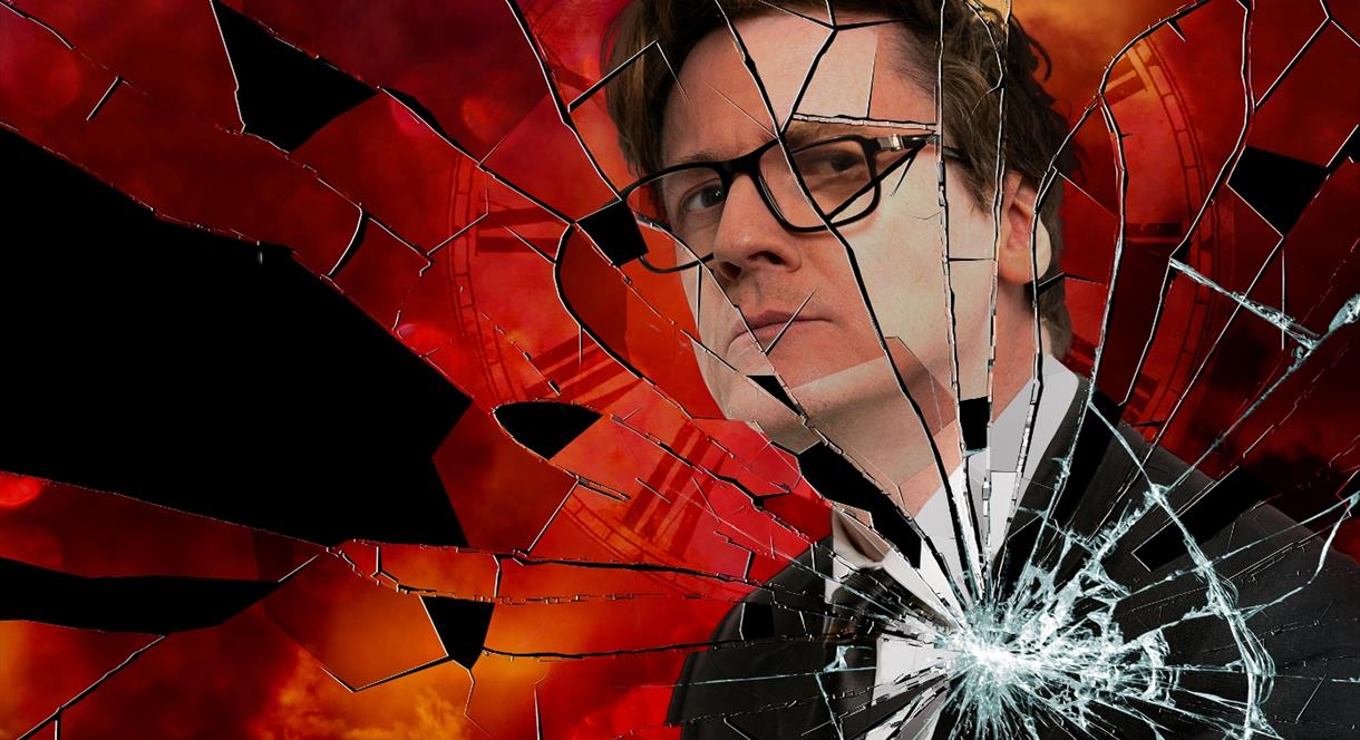 A promotional image for Ed Byrne's tour - a picture of Ed's reflection in a broken mirror