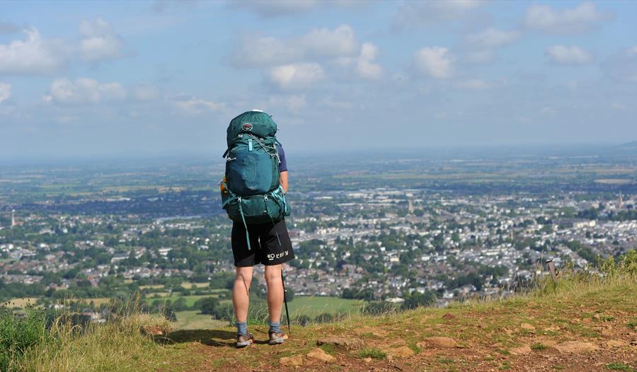 A man overlooking Cheltenham from Leckhampton Hill