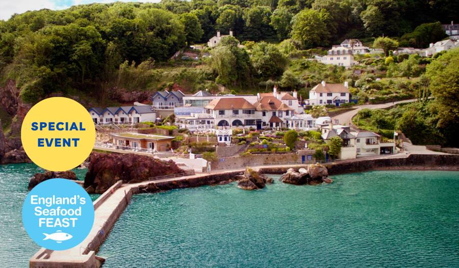 A view looking across the water to Cary Arms & Spa, with the pier in the foreground. Part of England's Seafood FEAST.