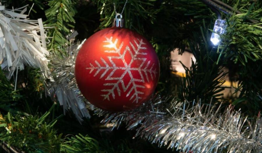 bauble on a christmas tree with silver tinsel in the background