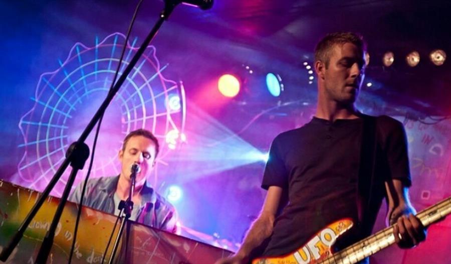 two members of the coldplace band performing on stage