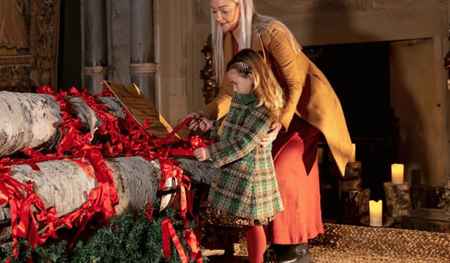 A woman and child inside Hardwick Hall at 'Wintertide'