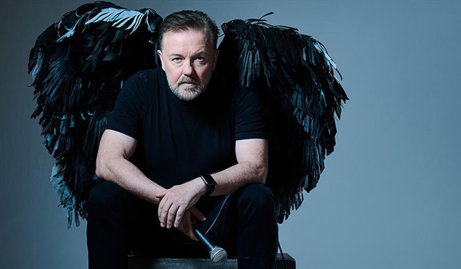 Photo of Ricky Gervais with black angel wings