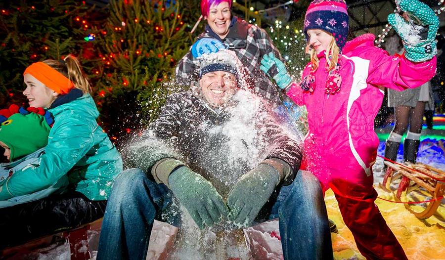 A family pelts Dad with snowballs at the Snowdome, Staffordshire