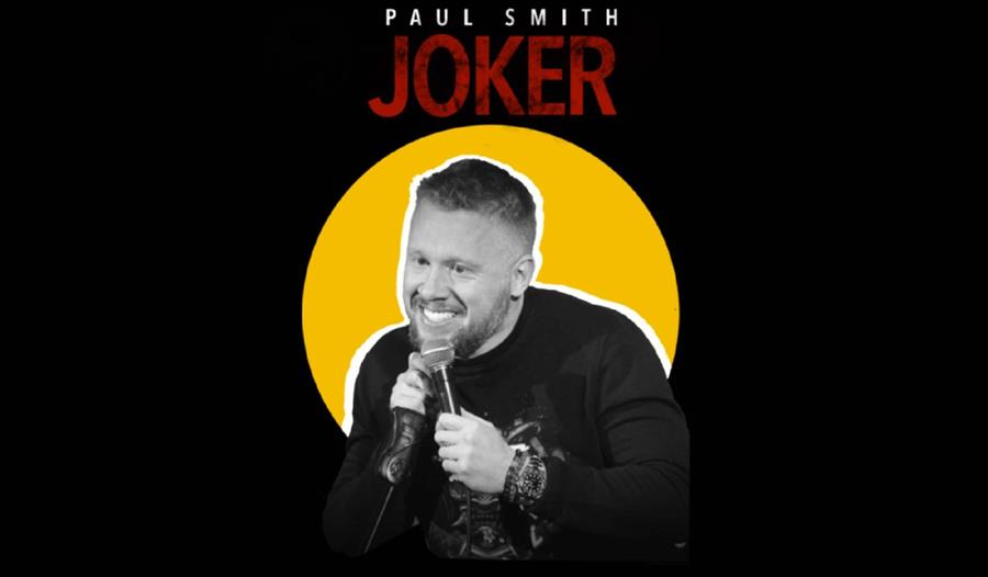 Image of Paul Smith holding a microphone.
