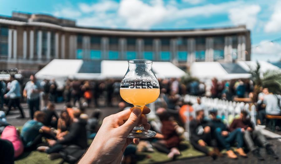 Hand holding beer at Bristol Craft Beer Festival
