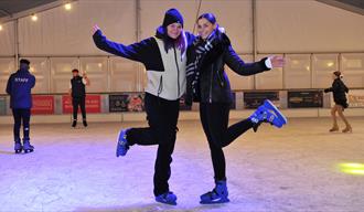 People skating on the ice rink.