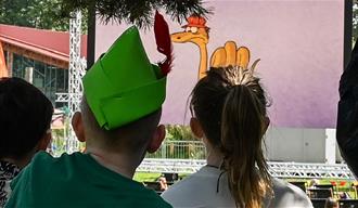 Photo of two young children looking at an outdoor cinema screen