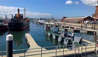 People on a boat at a Pontoon Open Day outside Boathouse 4