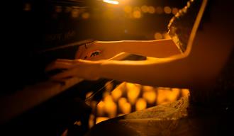 Female hands playing piano