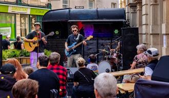 Band performing in the street at Old City Sounds 2024