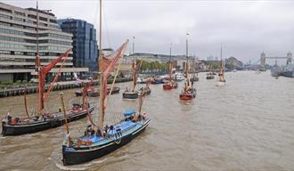 Boats on the water in front of Tower Bridge on the Thames.