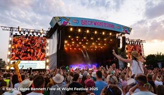 Crowds watching a band on the main stage at the Isle of Wight Festival, music event, what's on