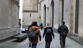 Daily Guided Walking Tour passing between Central Library and the Town Hall extension.