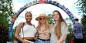 Ladies stood in front of the Jazz Festival sign.