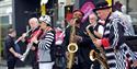 Live performance and crowds at Cheltenham High Street.