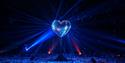 Glitterball heart illuminated by light beams