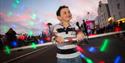 Boy having fun on Poole Quay before the big firework spectacle.