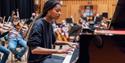 An image of a woman playing the piano