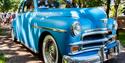 Vintage blue car with crowd behind it