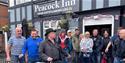People outside the Peacock Inn on the Brampton Mile Great Historic Pub Tour