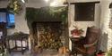 Downstairs at Revolution House with greenery swag, kissing bough and 12 Drummers Drumming flower arrangement.