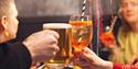 2 people cheersing their drinks