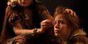 Actors dressed up as cave people