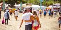 Couple cuddling and walking around the Isle of Wight Festival, music, events, what's on