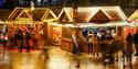 Long exposure of the Bournemouth Christmas markets and visitors shopping at the man stalls in the Square