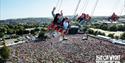 People on the swing ride in the air at the Isle of Wight Festival, music, events, what's on