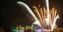 Castle lit with fireworks in foreground