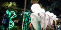 People dressed up for the arts festival in Bournemouths lower gardens at night