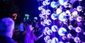Young girl admiring the interesting light up art exhibition