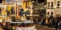 A Hollywood-themed carnival float with dancing performers on it at the Weston-super-Mare carnival