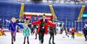 Photo of a holiday club with instructor and children on the ice