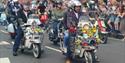 Isle of Wight Scooter Rally, image of Scooter Riders riding along road with onlookers applauding