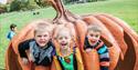 Three children hide in a giant pumpkin