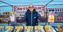 Braintree Market sweet stall with person holding sweets - Image