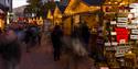 Crowds of people browsing the Christmas market stalls as they walk up Bournemouth high street