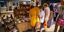Shoppers browsing a stall selling crafts