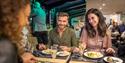 People eating dinner onboard City Cruises boat.