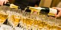 Champagne glasses being filled on a table