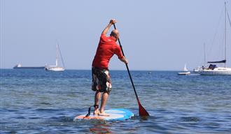 "learn to stand up paddleboard in studland"