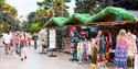 Market stalls and palm trees