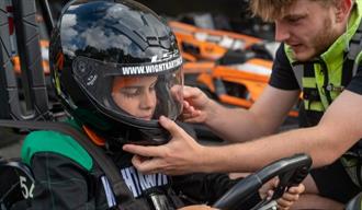 Man helping child with helmet before karting at Wight Karting, Ryde, Children's Events, junior track days