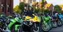 Green and yellow sport motorbikes parked up