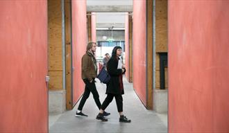 Two people exploring artists' studios at Spike Island, Bristol