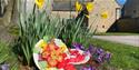Easter bonnets and daffodils in front of Dronfield Hall Barn