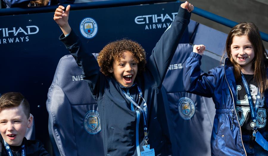 Boy cheering at Manchester City Stadium Tour